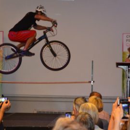 Stunt cyclist jumping over a pole at the Cheltenham Festival of Cycling launch