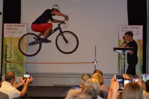 Stunt cyclist jumping over a pole at the Cheltenham Festival of Cycling launch